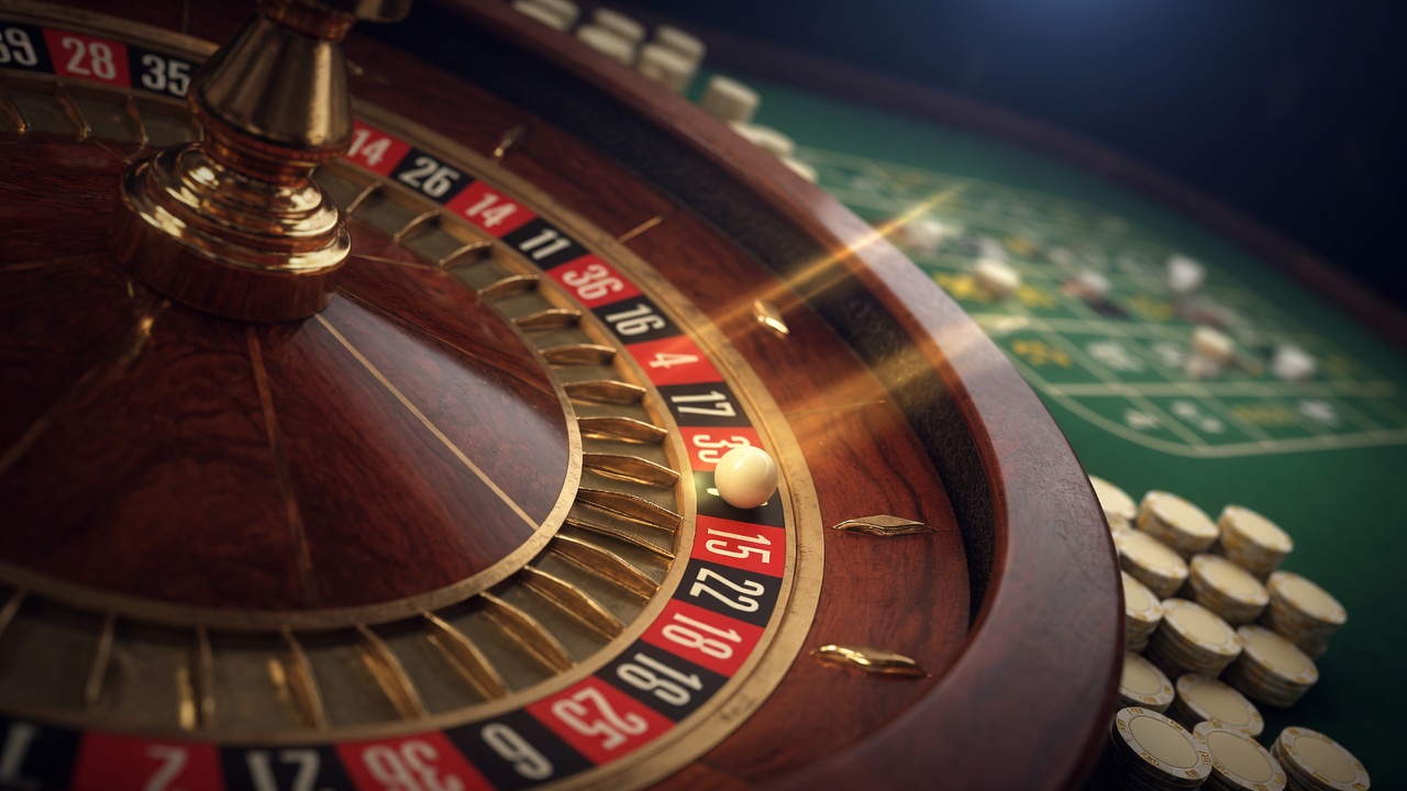 Close-up of a mahogany roulette wheel and ivory ball